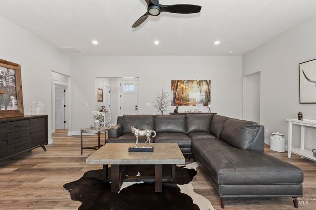 Living room with wood finished floors, a ceiling fan, and recessed lighting | Image 13