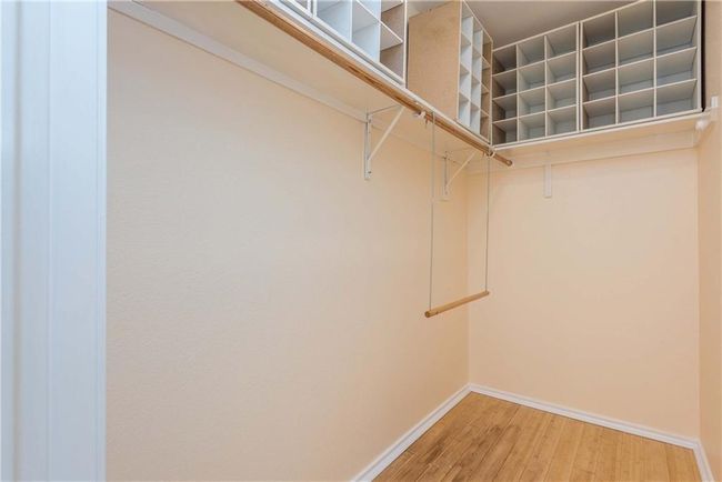 Spacious closet featuring light wood finished floors | Image 4