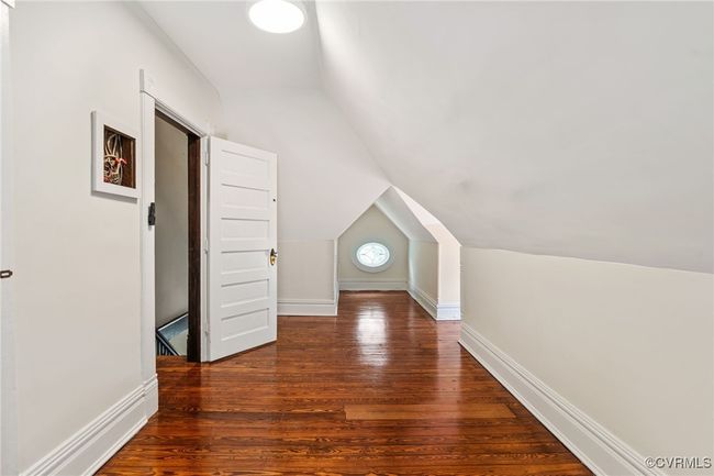 Bedroom with lofted ceiling, wood finished floors, and baseboards | Image 46