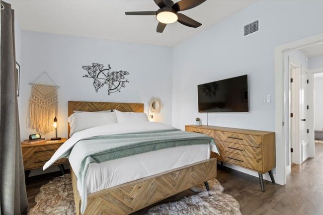 Bedroom with wood finished floors and ceiling fan | Image 13