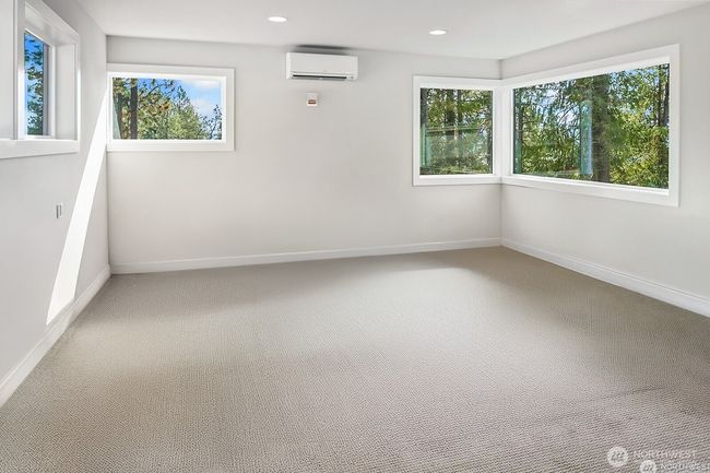The expansive bonus room with a full bath provides versatile flex space perfect for a home office, guest quarters, fitness room, theater, or more | Image 31