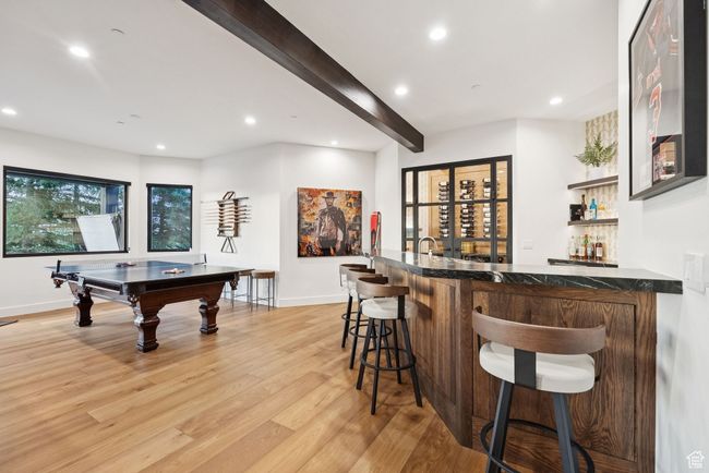Indoor wet bar featuring light wood-style flooring, recessed lighting, beamed ceiling, and billiards | Image 45