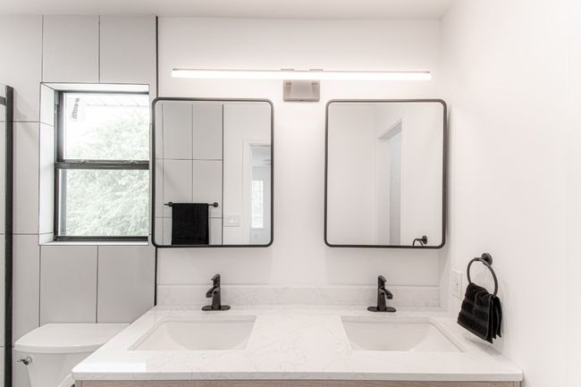 The primary bathroom was updated in February 2024. And features double vanities and tons of above and below storage. | Image 23
