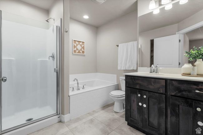 Bathroom with a shower stall, toilet, and a garden tub | Image 21