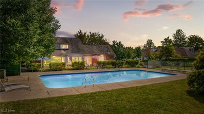 A stunning pool glistens in a lush 1.15-acre private oasis, surrounded by vibrant landscaping. A charming gazebo offers shade and relaxation, creating a perfect retreat for gatherings or quiet moments. | Image 2