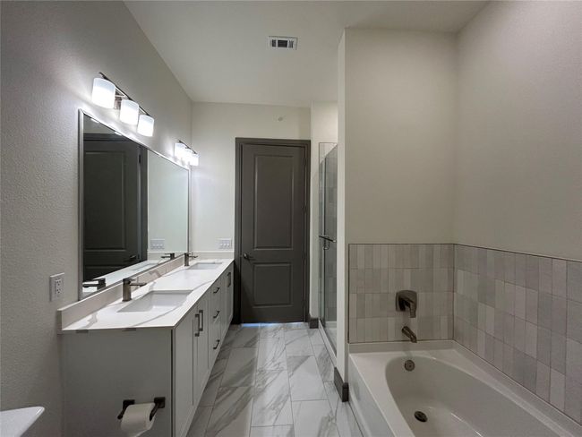 Bathroom with a bathing tub and vanity | Image 14
