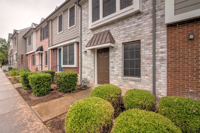 View of exterior entry with brick siding | Image 5
