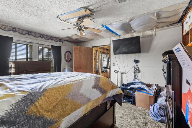 Bedroom featuring a textured ceiling and a ceiling fan | Image 14