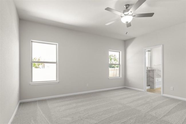 Unfurnished bedroom with light carpet, ensuite bathroom, baseboards, and a ceiling fan | Image 18