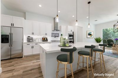 Seamlessly flowing kitchen with an inviting family room and dining area, perfect for entertaining and daily living. | Image 3