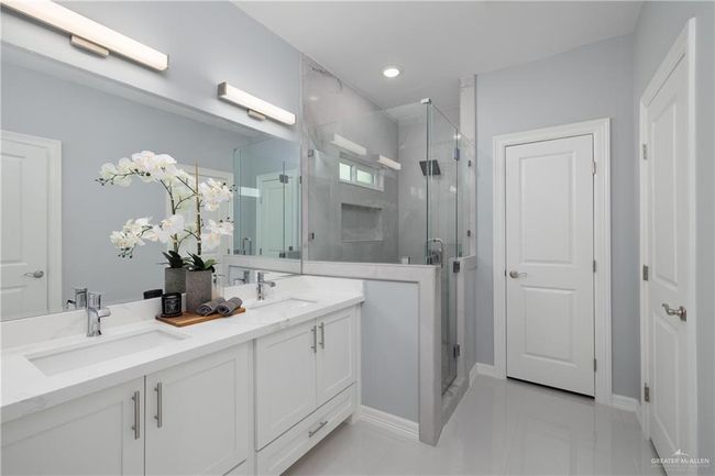 Bathroom featuring double vanity and a shower stall | Image 7