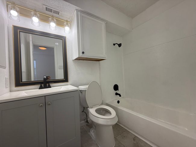 Bathroom with vanity, shower combination, and tile patterned flooring | Image 13