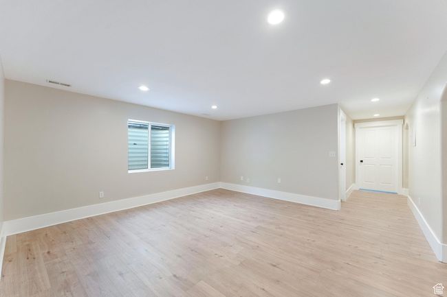 Basement family room with light wood-style floors and recessed lighting | Image 29