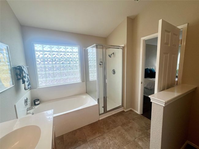 Full bathroom with a stall shower, a garden tub, and healthy amount of natural light | Image 23