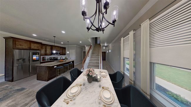 Virtually Staged. Dining room featuring light wood finished floors, stairway, crown molding, and an inviting chandelier | Image 6