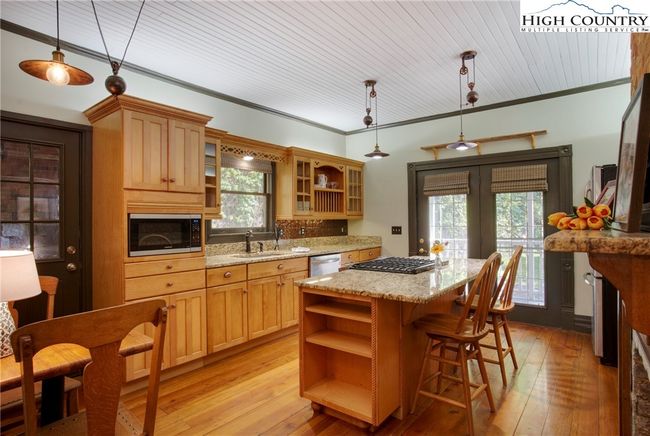 Updated kitchen with French doors to side deck and garage area | Image 11