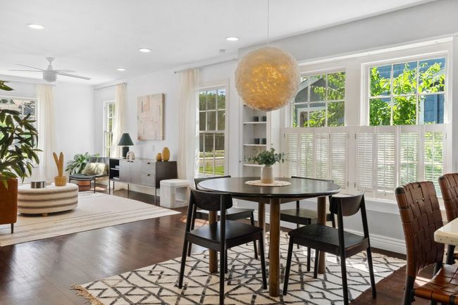 Wooden shutters, built in shelves, and a fun chandelier make this dining area stand out. | Image 7