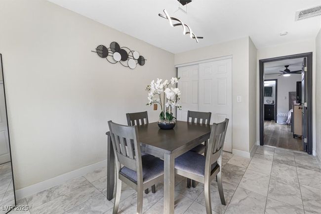 Dining space featuring visible vents, baseboards, and marble finish floor | Image 15