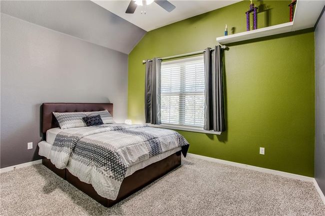 Carpeted bedroom with vaulted ceiling and ceiling fan | Image 17