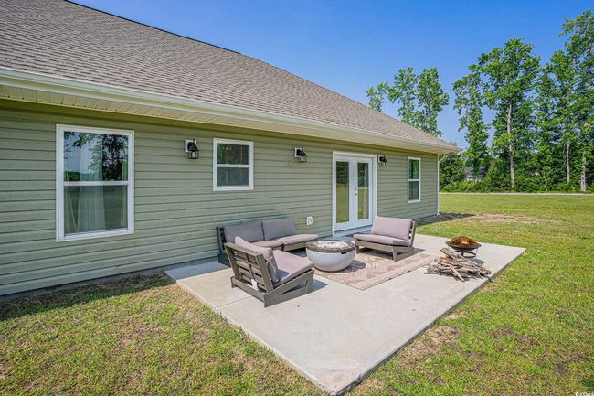 View of patio featuring french doors and an outdoor living space with a fire pit | Image 26