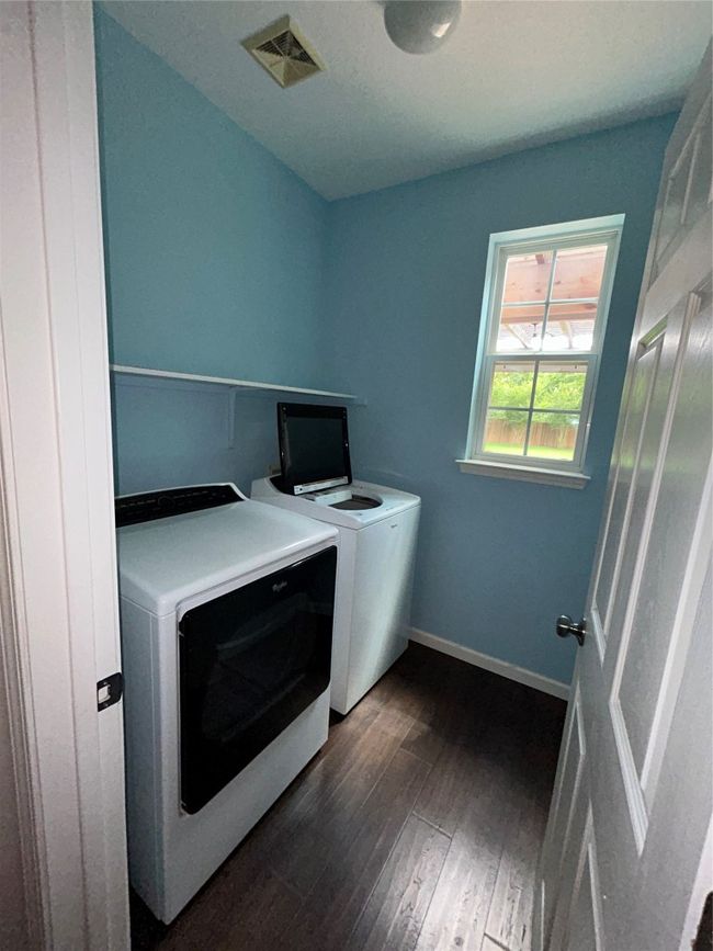 Washroom with separate washer and dryer, dark wood-style floors, and baseboards | Image 15