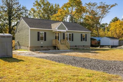 View of front facade with a storage unit and a front lawn | Image 2