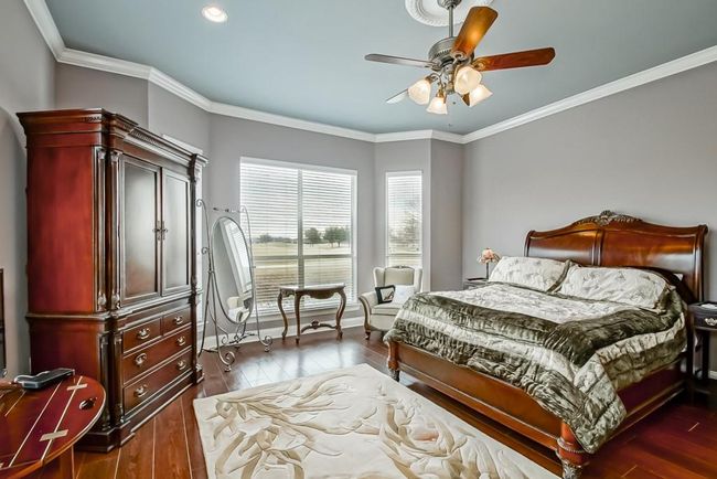 Huge Primary Bedroom with wood flooring, recessed lighting, ceiling fan/light. Lots of natural light. Wonderful views of the lake and golf course. | Image 19