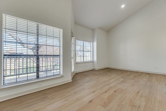 Spare room with lofted ceiling and light wood-type flooring | Image 25