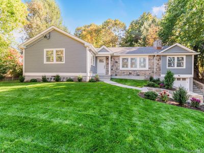 View of front of property featuring a garage and a front lawn | Image 1