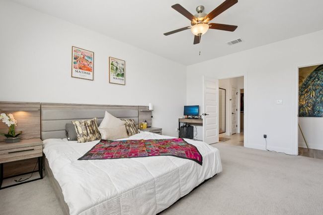 Carpeted bedroom featuring a ceiling fan and baseboards | Image 15