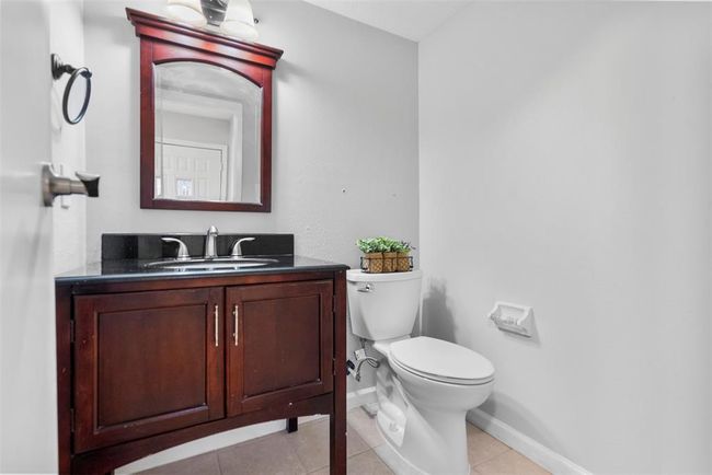 The downstairs half bath is perfect for guests. | Image 5