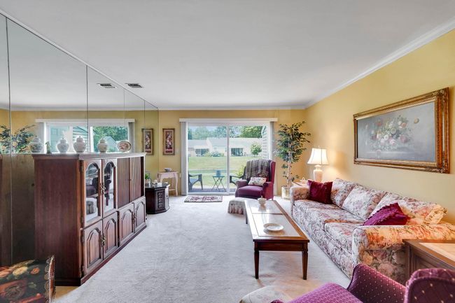 Living room with carpet and ornamental molding | Image 5