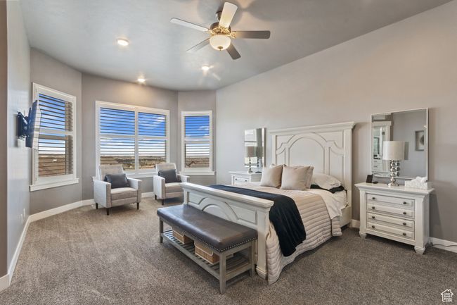 Bedroom featuring dark carpet, baseboards, and ceiling fan | Image 12