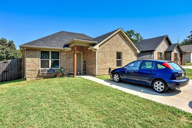 View of front of house with brick siding and roof with shingles | Image 10