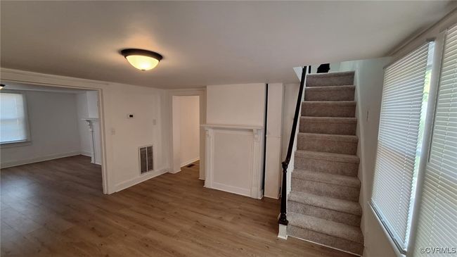Stairs featuring visible vents, baseboards, and wood finished floors | Image 8