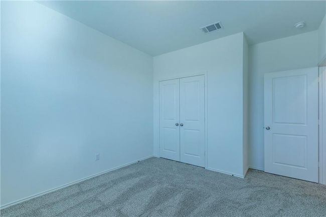 Unfurnished bedroom with carpet flooring and a closet | Image 23