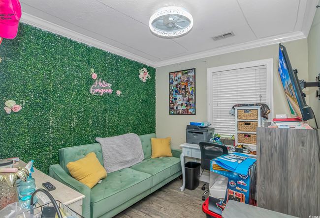 Living area with crown molding and wood finished floors | Image 15