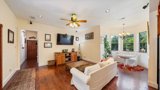 Living area with dark wood finished floors, baseboards, visible vents, and recessed lighting | Image 12
