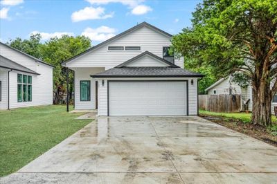 View of front of property with a garage and a front yard | Image 1