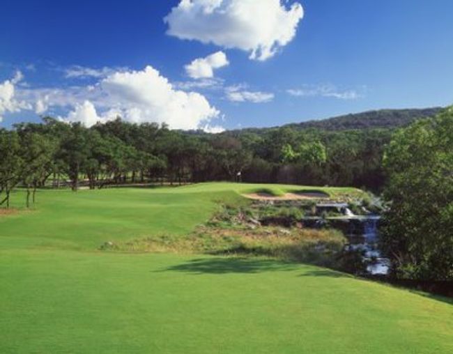 View of home's community with view of golf course, a view of trees, and a yard | Image 37