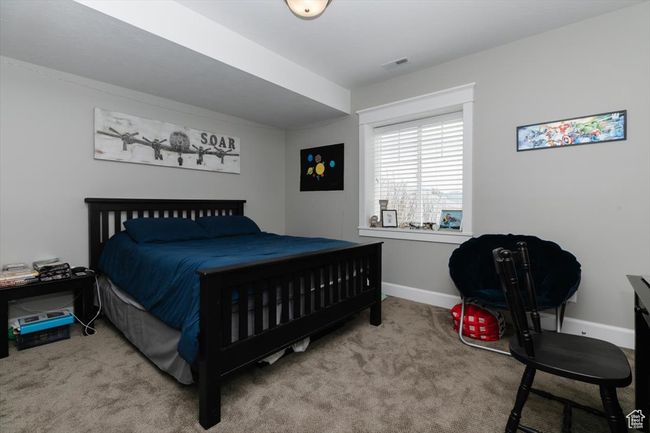 Bedroom with carpet floors, visible vents, and baseboards | Image 56