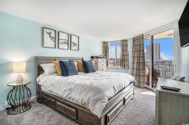 Bedroom featuring carpet floors, a textured ceiling, and access to outside | Image 14