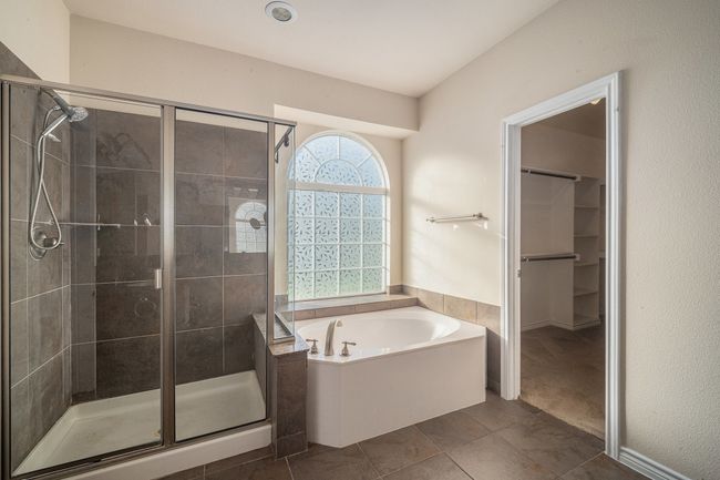 Bathroom featuring a stall shower, a bath, and a walk in closet | Image 31