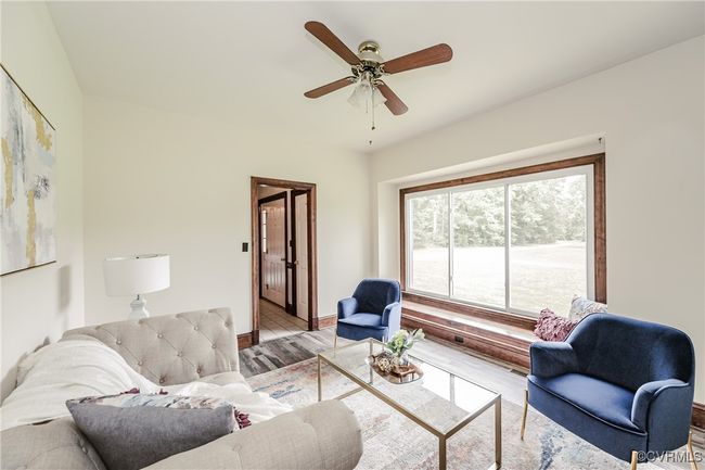 Living room with a ceiling fan and baseboards | Image 15