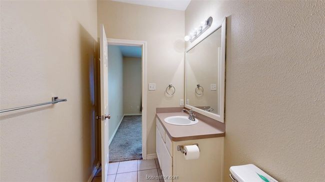 Bathroom featuring tile patterned floors, toilet, and vanity | Image 21
