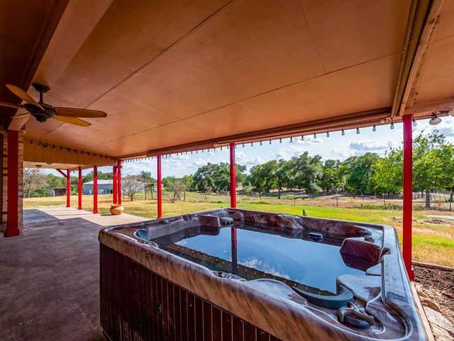 Relax in this wonderful hot tub on the covered back patio. Enjoy the view of the stock tank, barn and your farm animals. | Image 4