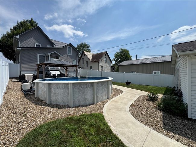 Back of property with pool and a fenced backyard | Image 35