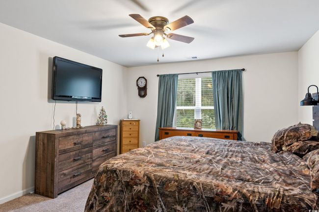 Carpeted bedroom with ceiling fan | Image 21