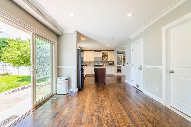 Kitchen with crown molding, open shelves, light countertops, recessed lighting, and freestanding refrigerator | Image 26