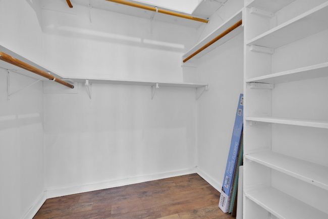 Spacious closet featuring dark wood-type flooring | Image 22